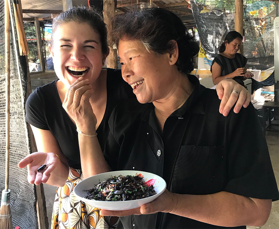 Afton in Northeastern Thailand enjoying some freshly roasted crickets with a Thai cricket farmer.
